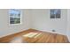 A bright bedroom with gleaming hardwood floors and natural light from two windows at 5205 Dunmoreland Ct, Atlanta, GA 30349