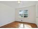 Cozy bedroom with gleaming hardwood floors and natural light from a large window at 5205 Dunmoreland Ct, Atlanta, GA 30349