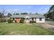 Charming one-story home featuring a brick facade, well-maintained lawn, and mature landscaping at 5205 Dunmoreland Ct, Atlanta, GA 30349