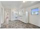 Well-lit kitchen with white cabinetry, stainless appliances, and sleek gray flooring at 5205 Dunmoreland Ct, Atlanta, GA 30349