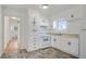 Functional kitchen with white cabinetry, stainless appliances, and a view to other rooms at 5205 Dunmoreland Ct, Atlanta, GA 30349