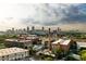 An aerial view of apartment buildings, a parking lot, and a cityscape on a cloudy day at 170 Boulevard Se # H523, Atlanta, GA 30312