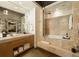 Modern bathroom with stone vanity, soaking tub, and glass shower enclosure; luxurious and serene at 170 Boulevard Se # H523, Atlanta, GA 30312
