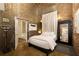 Inviting bedroom with white bedding, exposed brick, and industrial design elements at 170 Boulevard Se # H523, Atlanta, GA 30312