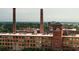 Brick building exterior showcasing large windows, chimneys, and rooftops with green trees background at 170 Boulevard Se # H523, Atlanta, GA 30312