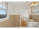 Cozy bathroom boasts tiled walls and floors, vanity and bright window at 2654 Jefferson Ter, Atlanta, GA 30344