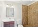 A tiled shower in a bathroom with a dark vanity and a modern lighting fixture at 2654 Jefferson Ter, Atlanta, GA 30344