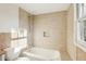 Bright bathroom offers tiled walls, a shower and bathtub, and a window for natural light at 2654 Jefferson Ter, Atlanta, GA 30344