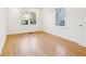 This bedroom features hardwood floors, two windows, and crisp white walls at 2654 Jefferson Ter, Atlanta, GA 30344