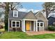 Charming home featuring a bright yellow front door, a brick walkway, and well-manicured lawn at 2654 Jefferson Ter, Atlanta, GA 30344