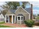 Home featuring a bright yellow front door, white columns, and well-manicured landscaping at 2654 Jefferson Ter, Atlanta, GA 30344