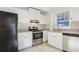 Bright kitchen features white cabinets, granite countertops, stainless steel appliances, and tile backsplash at 2654 Jefferson Ter, Atlanta, GA 30344
