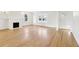 Open living room with a white fireplace, natural light, and hardwood flooring at 2654 Jefferson Ter, Atlanta, GA 30344