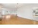 Open-concept living room featuring hardwood floors, fireplace, and a view of the kitchen at 2654 Jefferson Ter, Atlanta, GA 30344