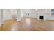 Spacious living room with hardwood floors, a white fireplace, and staircase at 2654 Jefferson Ter, Atlanta, GA 30344