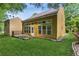 Back exterior featuring the backyard, a wall of windows, and a well-maintained lawn at 3277 Wyesham Cir, Duluth, GA 30096