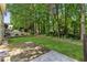 Well maintained backyard with small patio and trees at 3277 Wyesham Cir, Duluth, GA 30096