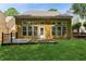 Back exterior featuring the backyard, a wall of windows, and a well-maintained lawn at 3277 Wyesham Cir, Duluth, GA 30096