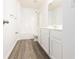 Clean bathroom featuring vinyl floors, white cabinets, and a shower-tub combo at 3277 Wyesham Cir, Duluth, GA 30096