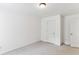 This bedroom includes neutral carpet, white walls, and two doors for easy access at 3277 Wyesham Cir, Duluth, GA 30096