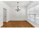 Elegant dining room with hardwood floors, wainscoting, and a modern chandelier at 3277 Wyesham Cir, Duluth, GA 30096