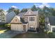 Two-story home with an attached garage, a well-kept lawn, mature trees, and neutral color palette at 3277 Wyesham Cir, Duluth, GA 30096