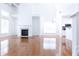Spacious living room featuring a fireplace and hardwood flooring adjacent to the kitchen at 3277 Wyesham Cir, Duluth, GA 30096