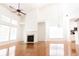 Bright living room featuring hardwood floors, fireplace, and an open floor plan connected to the kitchen at 3277 Wyesham Cir, Duluth, GA 30096