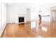 Bright living room featuring hardwood floors, fireplace, and an open floor plan connected to the kitchen at 3277 Wyesham Cir, Duluth, GA 30096