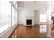 Bright living room featuring hardwood floors, fireplace, and an open floor plan connected to the kitchen at 3277 Wyesham Cir, Duluth, GA 30096