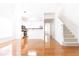 Open living space showcasing hardwood floors, a staircase, and a glimpse into a bright kitchen at 3277 Wyesham Cir, Duluth, GA 30096