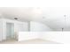 Spacious loft area with neutral carpet, white walls, and staircase access, offering versatile living space at 3277 Wyesham Cir, Duluth, GA 30096
