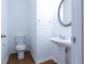 Cozy half-bathroom featuring modern fixtures and hardwood floors at 3277 Wyesham Cir, Duluth, GA 30096