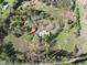 Aerial view of home with outbuildings surrounded by green lawn and mature trees at 512 E Valley Ne Rd, Rydal, GA 30171