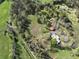 Aerial view showcases home with detached garage surrounded by lush greenery and mature trees at 512 E Valley Ne Rd, Rydal, GA 30171