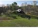 Aerial view of home featuring large lot, outbuildings, and wooded surroundings at 512 E Valley Ne Rd, Rydal, GA 30171