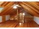 Charming attic space featuring wood beams, flooring, and a ceiling fan at 512 E Valley Ne Rd, Rydal, GA 30171