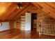 Bright attic space with wood beam ceiling and hardwood floors, open layout, and built-in shelving at 512 E Valley Ne Rd, Rydal, GA 30171