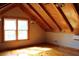 Attic bedroom with wood beam ceiling and hardwood floors, filled with natural light at 512 E Valley Ne Rd, Rydal, GA 30171