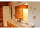 Bathroom featuring a double sink vanity with generous counterspace and wood trim at 512 E Valley Ne Rd, Rydal, GA 30171