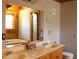 Bathroom featuring a double sink vanity with generous counterspace and wood trim at 512 E Valley Ne Rd, Rydal, GA 30171