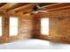 Cozy bedroom featuring wood-paneled walls and two bright windows offering plenty of natural light at 512 E Valley Ne Rd, Rydal, GA 30171