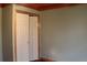 Bedroom featuring a closet with bi-fold doors, hardwood trim, and a minimalist color palette at 512 E Valley Ne Rd, Rydal, GA 30171