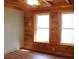 Bright bedroom with hardwood accents, natural light, and wood paneled walls at 512 E Valley Ne Rd, Rydal, GA 30171