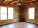 Empty bedroom features beautiful hardwood paneling and floor and 2 windows for natural light at 512 E Valley Ne Rd, Rydal, GA 30171