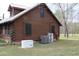 Side exterior view of log home featuring a generator, AC units, and a metal roof at 512 E Valley Ne Rd, Rydal, GA 30171