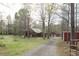 Exterior view of home and outbuildings with a long gravel driveway and spacious yard at 512 E Valley Ne Rd, Rydal, GA 30171