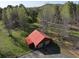 Aerial view of a detached garage featuring a red roof and adjacent parking at 512 E Valley Ne Rd, Rydal, GA 30171