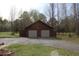 Two-car detached garage with wide driveway and green lawn at 512 E Valley Ne Rd, Rydal, GA 30171