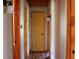 Hallway with neutral walls, hardwood trim, and multiple doors leading to different rooms at 512 E Valley Ne Rd, Rydal, GA 30171
